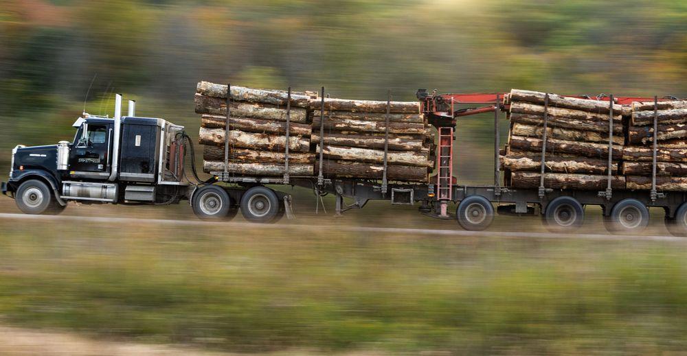 Flatbed trailer hauling heavy equipment