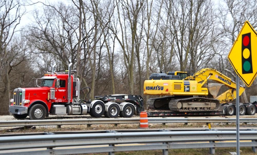 Step deck drop-deck trailer carrying a machine